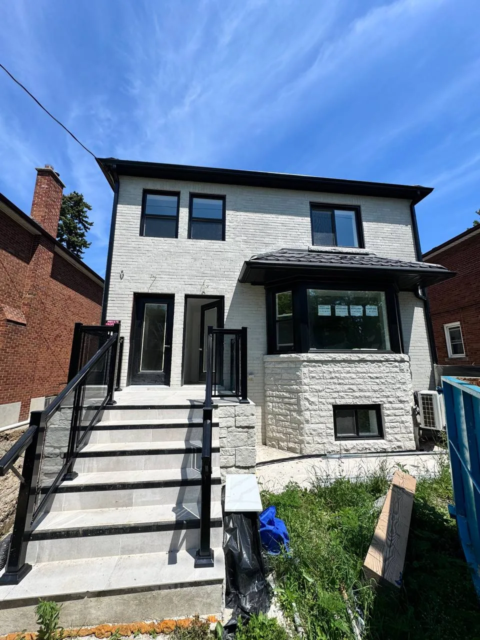 CNB project — two-storey home with glass railing entrance, GTA